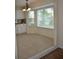 Bright dining area with large windows, chandelier, and modern white cabinets with granite countertops at 6548 Sw 84Th Place Rd, Ocala, FL 34476