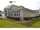 Angled exterior view showcasing the home's side and front, blue shutters, and foundation plantings at 6548 Sw 84Th Place Rd, Ocala, FL 34476