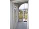 View from the front door looking onto a screened entry porch, showcasing outdoor landscape at 6548 Sw 84Th Place Rd, Ocala, FL 34476