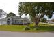 Exterior of a single-story home with lawn and landscaping; mature tree on the right at 6548 Sw 84Th Place Rd, Ocala, FL 34476