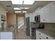 Well-lit kitchen with granite counters, stainless steel appliances, and ample cabinet storage at 6548 Sw 84Th Place Rd, Ocala, FL 34476