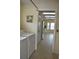 Convenient laundry room leading to the kitchen with stainless steel appliances and bright lighting at 6548 Sw 84Th Place Rd, Ocala, FL 34476