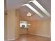 Open-concept living room with vaulted ceiling, hardwood floors, and connection to the kitchen at 6548 Sw 84Th Place Rd, Ocala, FL 34476