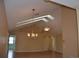 Open living space with hardwood floors, light-colored walls, and unique ceiling with fan and pendant lighting at 6548 Sw 84Th Place Rd, Ocala, FL 34476
