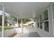 A covered patio features a concrete floor, white fence, and view of the surrounding neighborhood at 6548 Sw 84Th Place Rd, Ocala, FL 34476