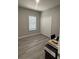 Bedroom featuring wood-look flooring and a large closet at 6884 Sw 149Th Lane Rd, Ocala, FL 34473