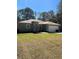 Charming single story home featuring a well-maintained lawn, attached garage, and welcoming entrance at 6884 Sw 149Th Lane Rd, Ocala, FL 34473