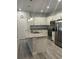 Modern kitchen featuring white cabinets, stainless steel appliances, and a center island with breakfast bar at 6884 Sw 149Th Lane Rd, Ocala, FL 34473