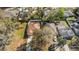 Birds eye view of a home with a fenced-in backyard and mature trees in a suburban neighborhood at 811 Niles St, Daytona Beach, FL 32114