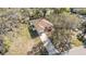 Overhead angle of a home with neutral siding, a long driveway, and green fenced yard at 811 Niles St, Daytona Beach, FL 32114