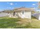View of the back corner of the home showing a window and door to the backyard at 811 Niles St, Daytona Beach, FL 32114