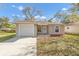 Charming single-story home featuring an attached garage and manicured front yard at 811 Niles St, Daytona Beach, FL 32114