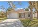 Charming single-story home featuring a driveway and attached garage at 811 Niles St, Daytona Beach, FL 32114