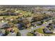 A high angle view of the homes near the golf course surrounded by trees in the area at 8740 Se 140Th Place Rd, Summerfield, FL 34491