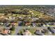 Aerial view of the homes surrounding a golf course and wooded area in the area at 8740 Se 140Th Place Rd, Summerfield, FL 34491