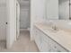 Bright bathroom featuring a white vanity, mirror, and walk-in shower for a clean, modern look at 8740 Se 140Th Place Rd, Summerfield, FL 34491