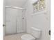 Bathroom featuring a glass-enclosed shower and updated toilet at 8740 Se 140Th Place Rd, Summerfield, FL 34491