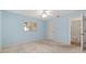 Light blue bedroom with a window and carpeted floors at 8740 Se 140Th Place Rd, Summerfield, FL 34491