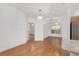 Elegant dining area with chandelier and wood floors, adjacent to kitchen at 8740 Se 140Th Place Rd, Summerfield, FL 34491
