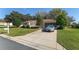 Lovely single-story home with an attached garage, car in driveway, and a meticulously maintained lawn at 8740 Se 140Th Place Rd, Summerfield, FL 34491
