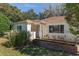 A cozy home with a neat yard, featuring classic suburban landscaping and a welcoming entrance at 8740 Se 140Th Place Rd, Summerfield, FL 34491