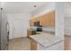 Well-equipped kitchen with stainless steel appliances, light wood cabinets, and a spacious countertop at 8740 Se 140Th Place Rd, Summerfield, FL 34491