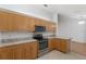 Open kitchen featuring light wood cabinets, stainless appliances, and functional layout at 8740 Se 140Th Place Rd, Summerfield, FL 34491