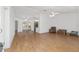 Bright living room with wood floors, creating a welcoming and airy atmosphere at 8740 Se 140Th Place Rd, Summerfield, FL 34491