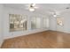Sunlit living room with wood floors, ceiling fans, and ample natural light at 8740 Se 140Th Place Rd, Summerfield, FL 34491