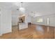 Open living area with wood floors, blending kitchen, dining, and living spaces at 8740 Se 140Th Place Rd, Summerfield, FL 34491