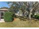 Spacious yard with mature trees and lush landscaping; backyard is perfect for outdoor activities at 8740 Se 140Th Place Rd, Summerfield, FL 34491