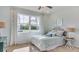 Charming bedroom with a large window, ceiling fan, and a comfortable bed with decorative pillows at 9356 Sw 60Th Court Rd, Ocala, FL 34476