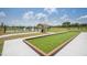 Community bocce ball court and picnic area with a gazebo, surrounded by lush green grass at 9356 Sw 60Th Court Rd, Ocala, FL 34476
