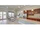 Stylish kitchenette with stainless steel appliances, granite countertop, and cozy seating area at 9356 Sw 60Th Court Rd, Ocala, FL 34476