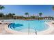 Beautiful community pool with a clear blue water, resort-style seating, and palm trees at 9356 Sw 60Th Court Rd, Ocala, FL 34476
