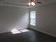 Well-lit bedroom with a window, tray ceiling with fan, and wood-look floors, great lighting at 9455 Se 152Nd Pl, Summerfield, FL 34491