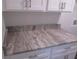 Close-up of a granite countertop with attractive gray and beige veining at 9455 Se 152Nd Pl, Summerfield, FL 34491