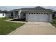 Beautiful single-story home with a two-car garage and a well-maintained lawn and landscaping at 9455 Se 152Nd Pl, Summerfield, FL 34491