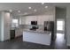 Bright kitchen with white cabinets, stainless steel appliances, and a center island, offering ample counter space at 9455 Se 152Nd Pl, Summerfield, FL 34491
