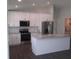 Modern kitchen featuring white cabinets, stainless steel appliances, and a kitchen island at 9455 Se 152Nd Pl, Summerfield, FL 34491
