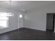 Bright living room features a modern pendant light and light-filled window near the entry door at 9455 Se 152Nd Pl, Summerfield, FL 34491