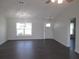 Bright living room with wood floors, a front door, and natural light from a large window at 9455 Se 152Nd Pl, Summerfield, FL 34491