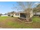 Spacious backyard featuring a well-maintained lawn and mature trees at 9710 Sw 96Th St, Ocala, FL 34481
