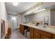 Bathroom featuring a large countertop with double sinks, ample lighting, and a glass-enclosed shower at 9710 Sw 96Th St, Ocala, FL 34481