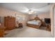 This cozy bedroom includes a wooden bed set, rocking chair, and an abundance of natural light at 9710 Sw 96Th St, Ocala, FL 34481