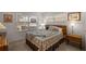 Cozy bedroom features natural light, a comfortable bed, and charming decor elements throughout at 9710 Sw 96Th St, Ocala, FL 34481