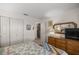 This bedroom has ample closet space, neutral walls, and a stylish dresser with a woven mirror above it at 9710 Sw 96Th St, Ocala, FL 34481