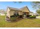 Inviting home exterior boasting a well-kept lawn, mature plantings and a cozy front porch at 9710 Sw 96Th St, Ocala, FL 34481