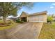Charming home exterior featuring a well-manicured lawn, shrubs and spacious driveway at 9710 Sw 96Th St, Ocala, FL 34481