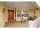 Inviting front porch with chairs and a skeleton statue at 9710 Sw 96Th St, Ocala, FL 34481